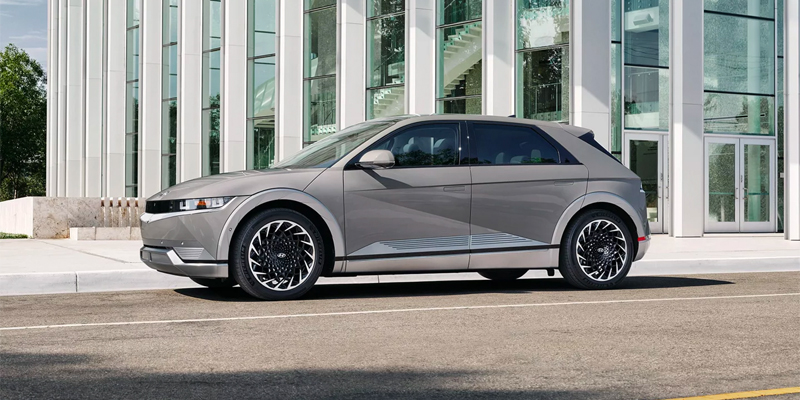 A used 2023 Hyundai IONIQ5 parked outside a stylish building in San Antonio, TX