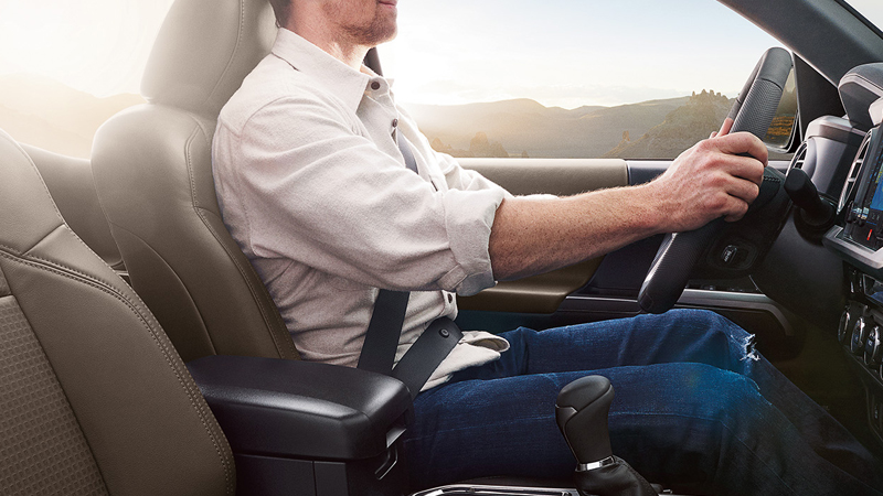 A driver taking a seat in their used Toyota Tacoma in San Antonio, TX