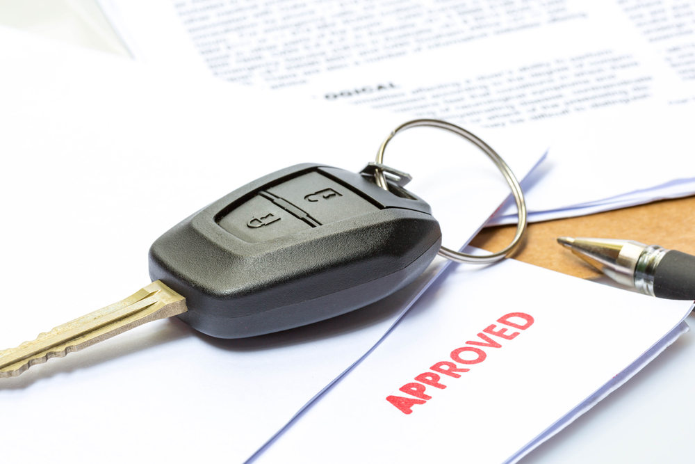Car key and approved financing form for vehicle purchase in San Antonio, TX illustrating why vehicle payments look different than a few years ago